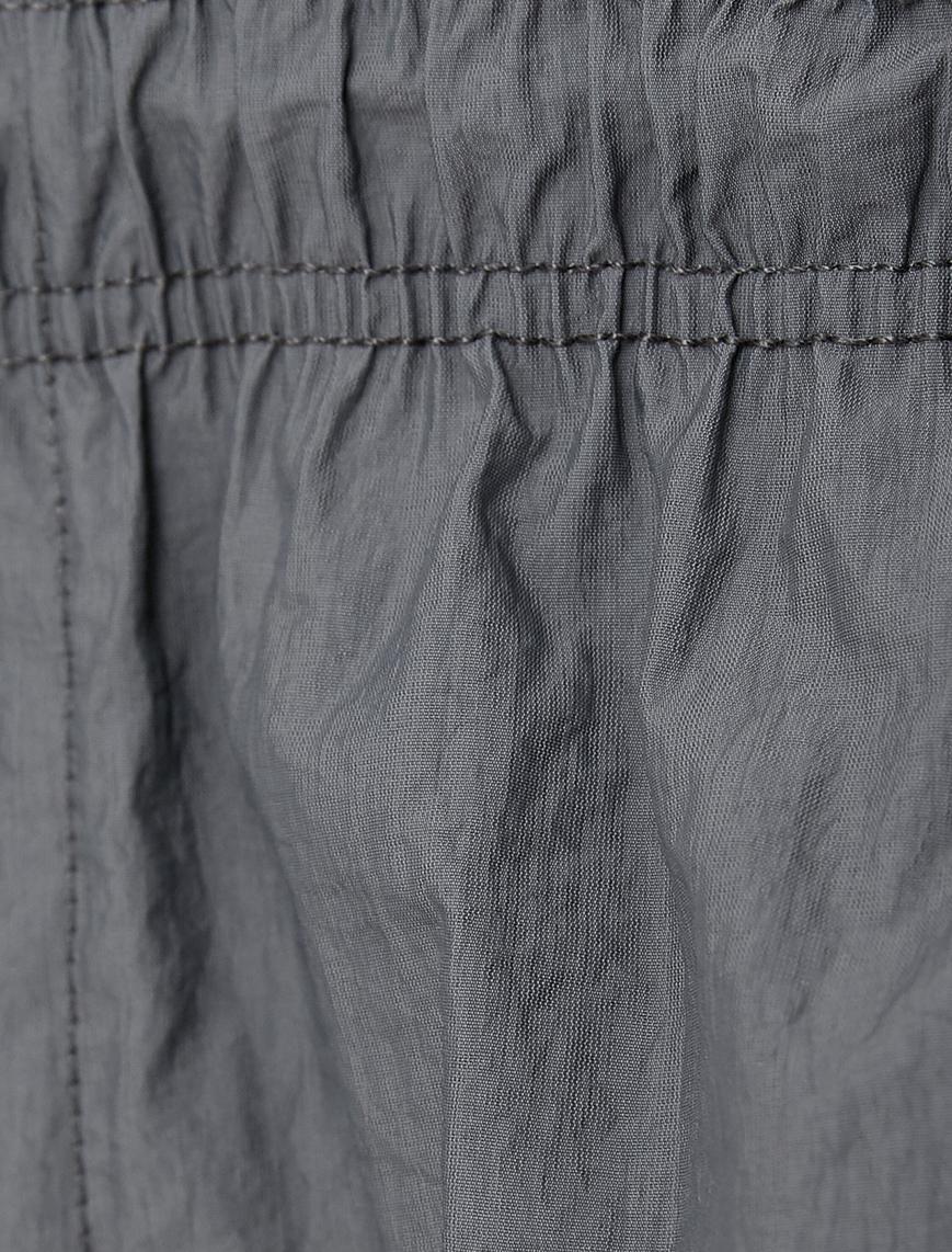   Paraşüt Pantolon Bol Kesim Beli Bağcıklı Paçası Lastikli Cep Detaylı