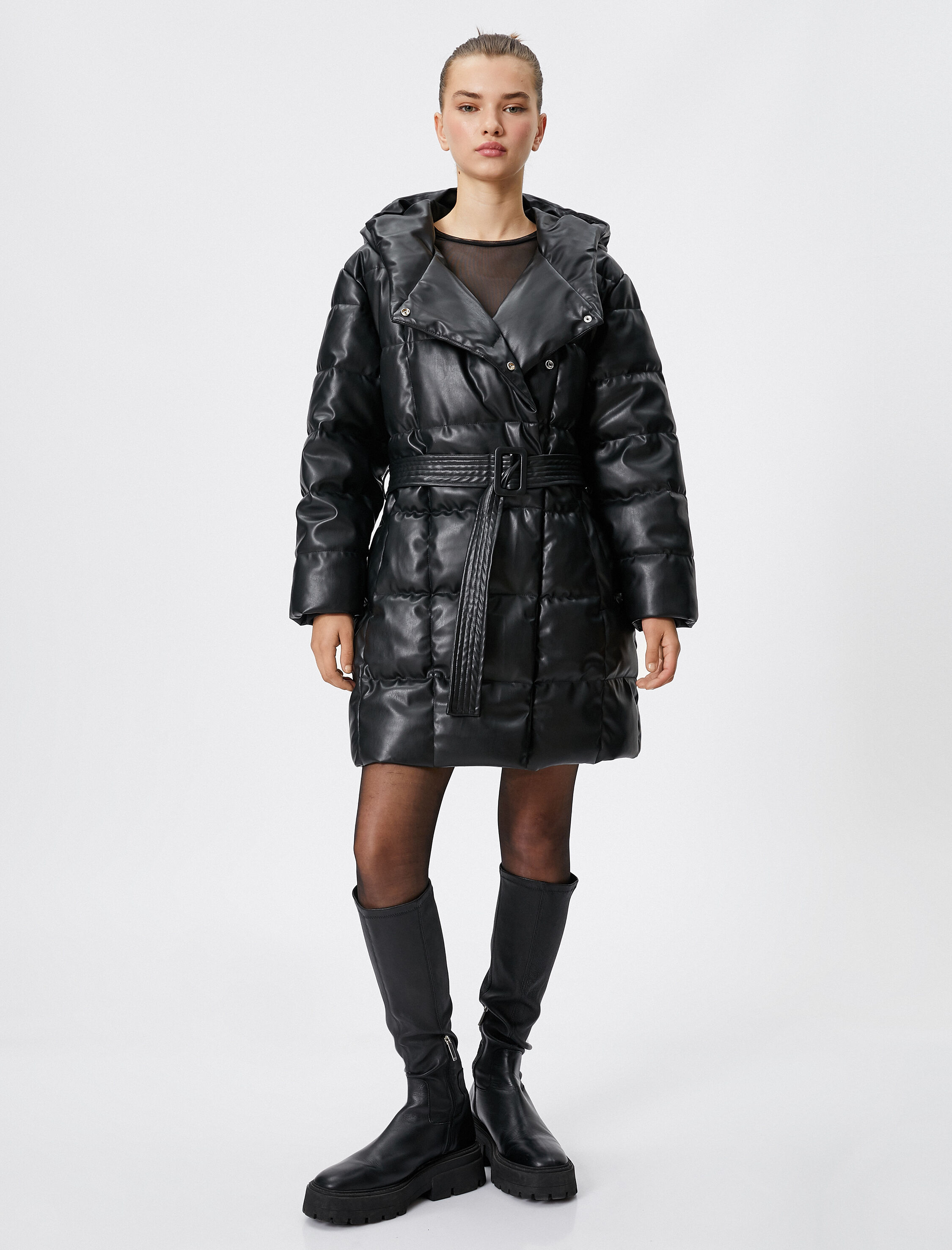   Şişme Uzun Mont Deri Görünümlü Kapüşonlu Kemer Detaylı Cepli Kapitone