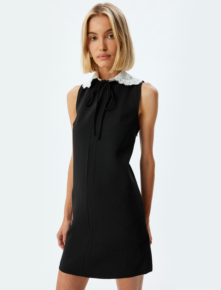  A Kesim Bağlama Detaylı Kolsuz Dantel Bebe Yaka Mini Elbise