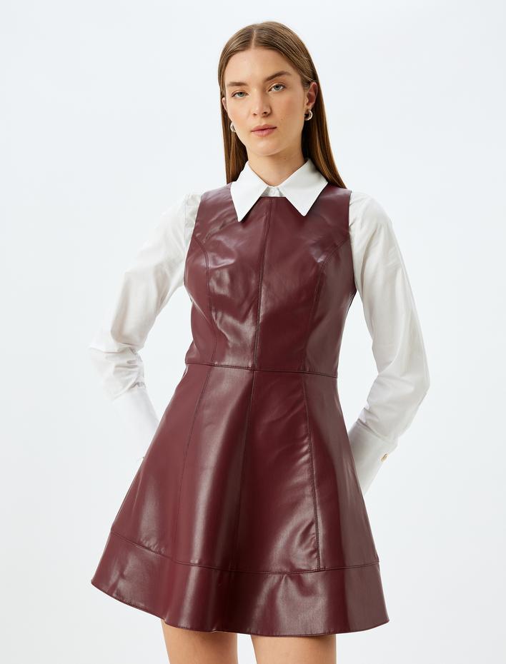  A Kesim Yuvarlak Yaka Kolsuz Parlak Mini Suni Deri Elbise