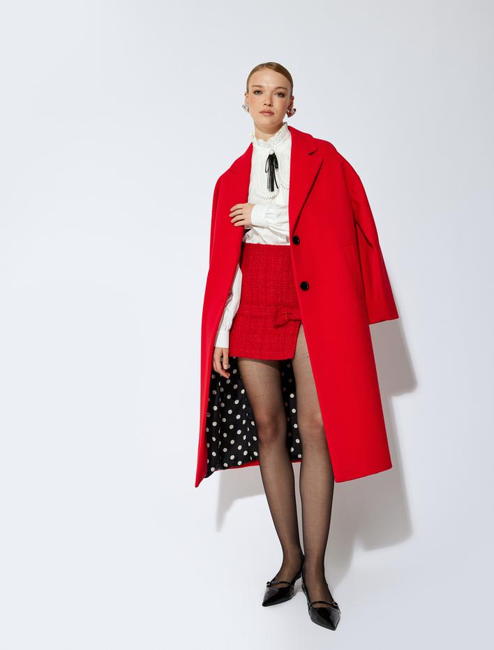  Koton X Sibil Çetinkaya - A Kesim Yırtmaçlı Fiyonk Detaylı Mini Tüvit Etek