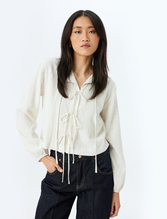  Geniş Kalıp Viskon Keten Karışımlı Uzun Kollu Dokulu Fiyonk Bağlama Detaylı Kısa Bluz