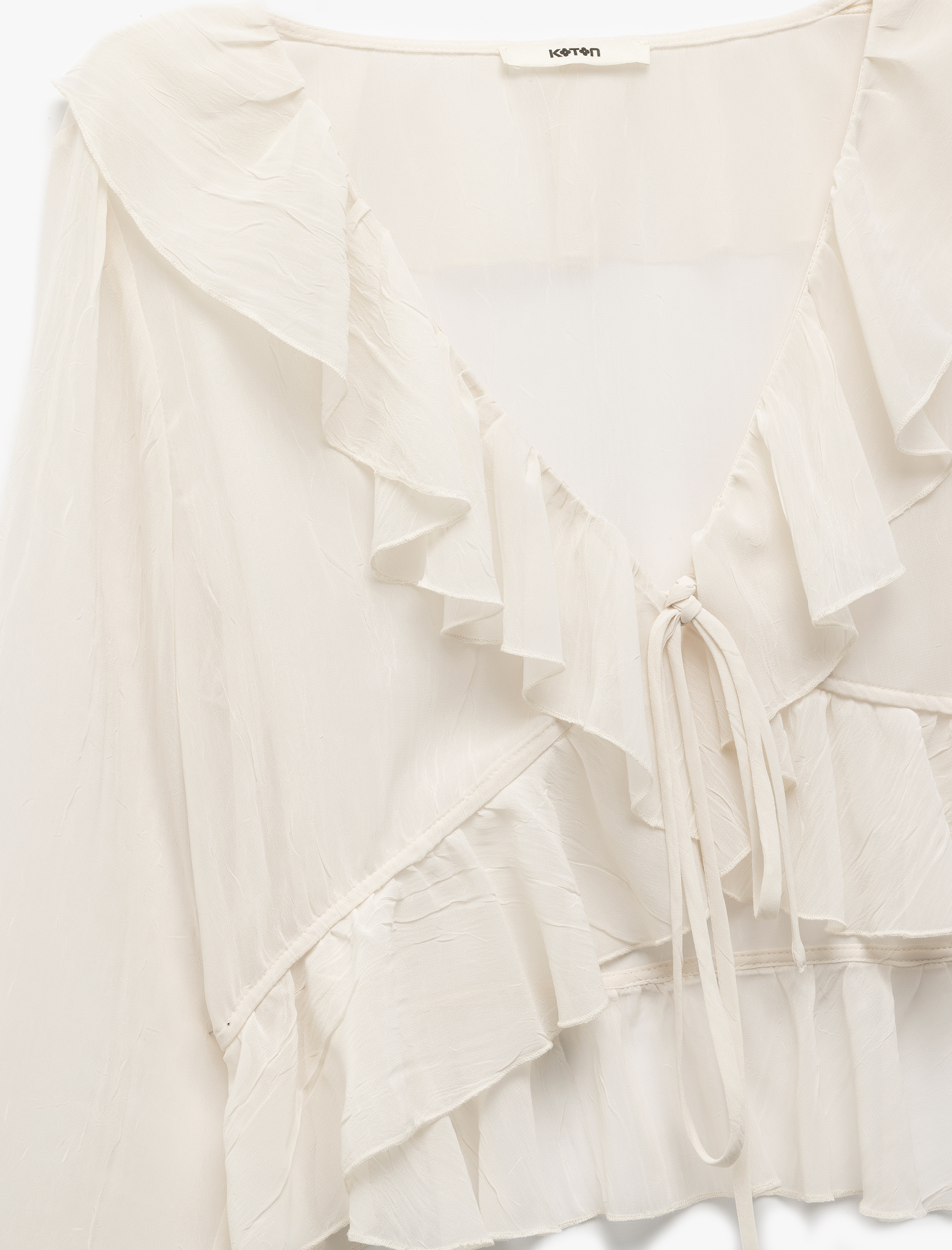 Önden Bağlama Detaylı Asimetrik Uzun Kollu Fırfırlı Crop Bluz