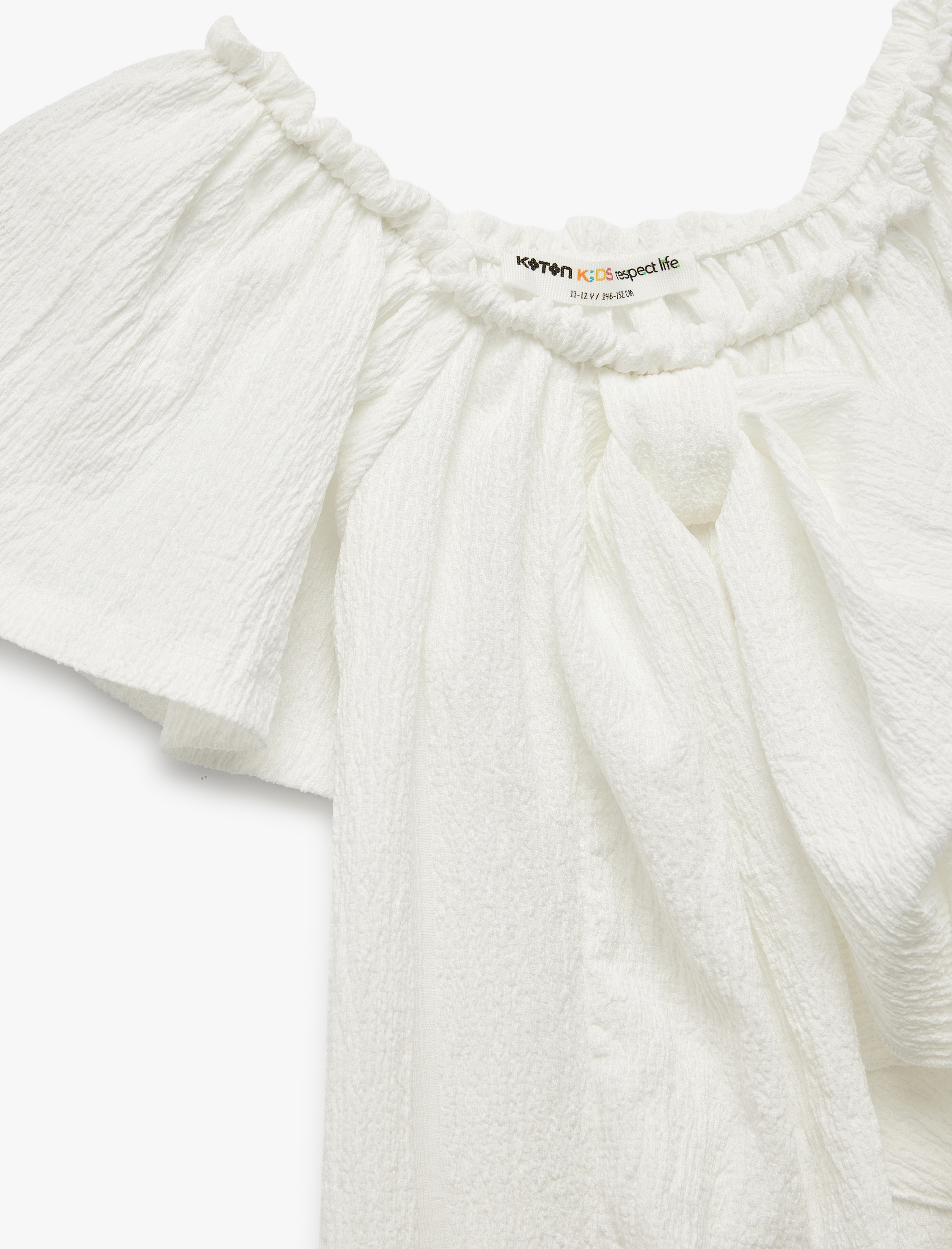  Kız Çocuk Bürümcük Kumaş Fiyonklu Omzu Açık Fırfırlı Kısa Kollu Bluz