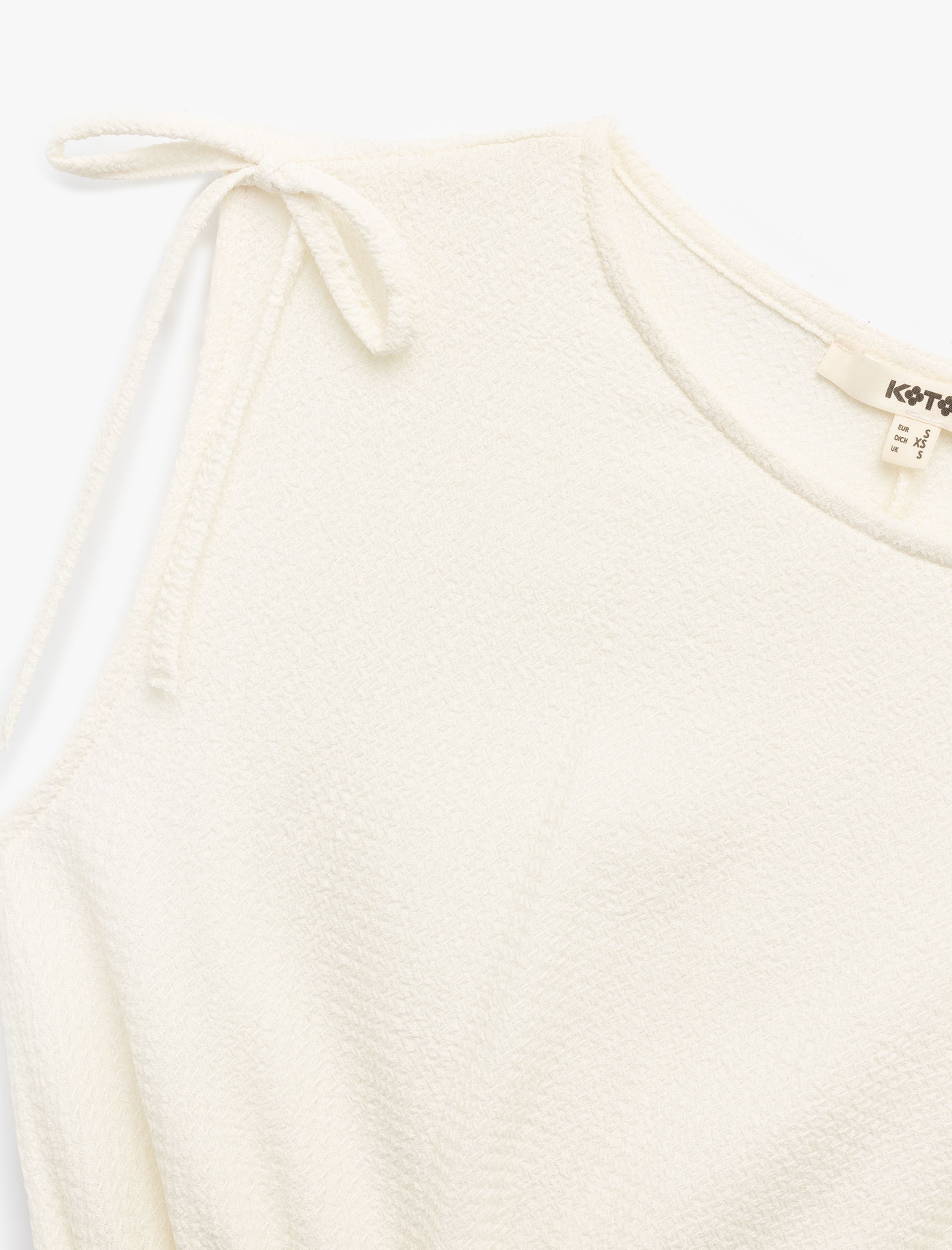   Bürümcük Kumaş Gipeli Fiyonk Detaylı Kolsuz Bisiklet Yaka Bluz