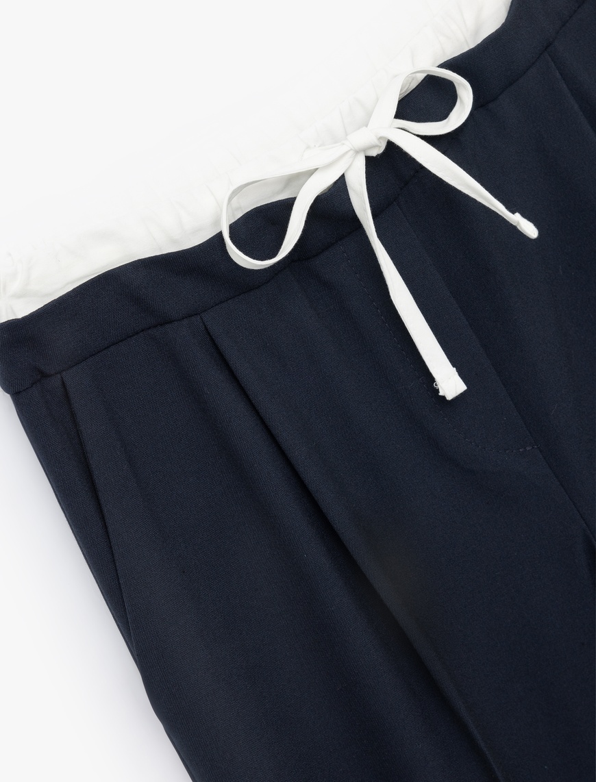   Ekstra Kumaş Detaylı Beli Bağlamalı Cepli Geniş Paça Baggy Pantolon