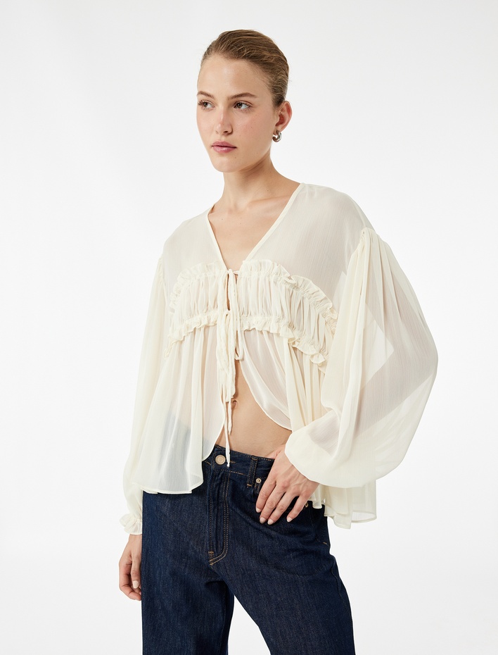  Uzun Kollu V Yaka Önden Bağlamalı Fiyonk Detaylı Fırfırlı Bluz