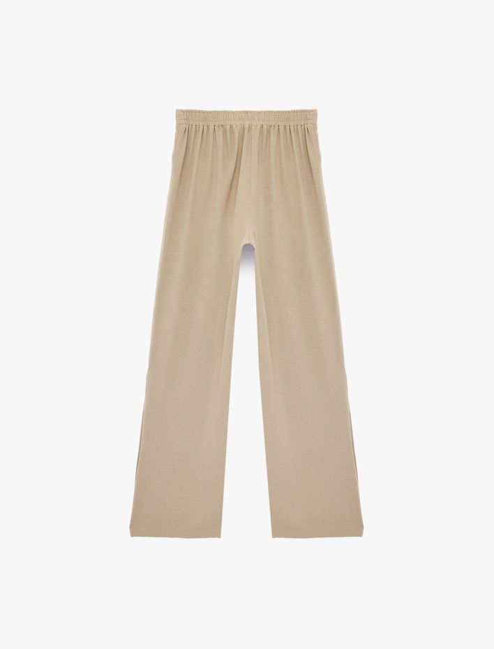  Beli Lastikli Yanları Yırtmaç Detaylı Düz Geniş Paça Pantolon