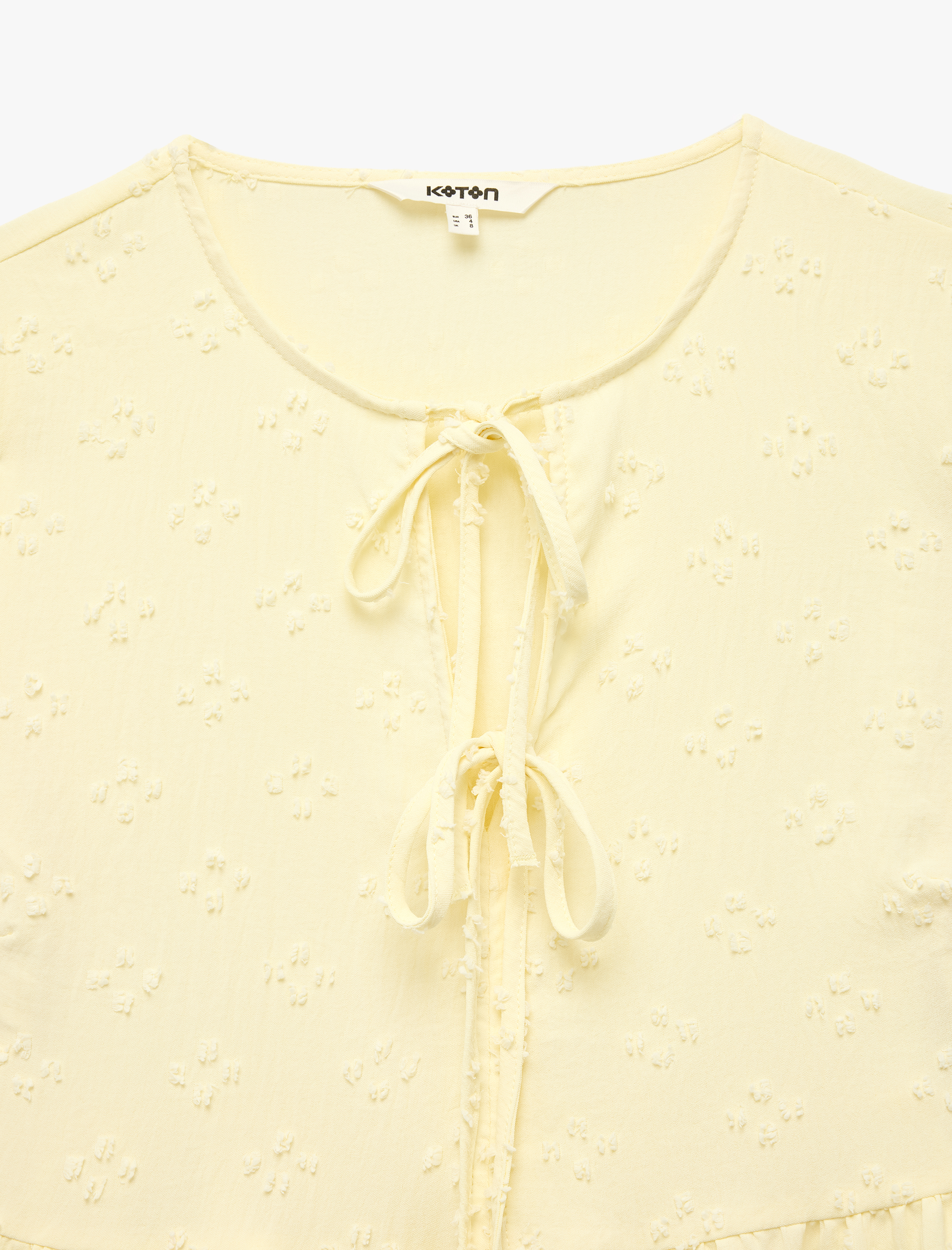   Bağlamalı Fiyonk Detaylı Kısa Kollu Dokulu Peplum Bluz