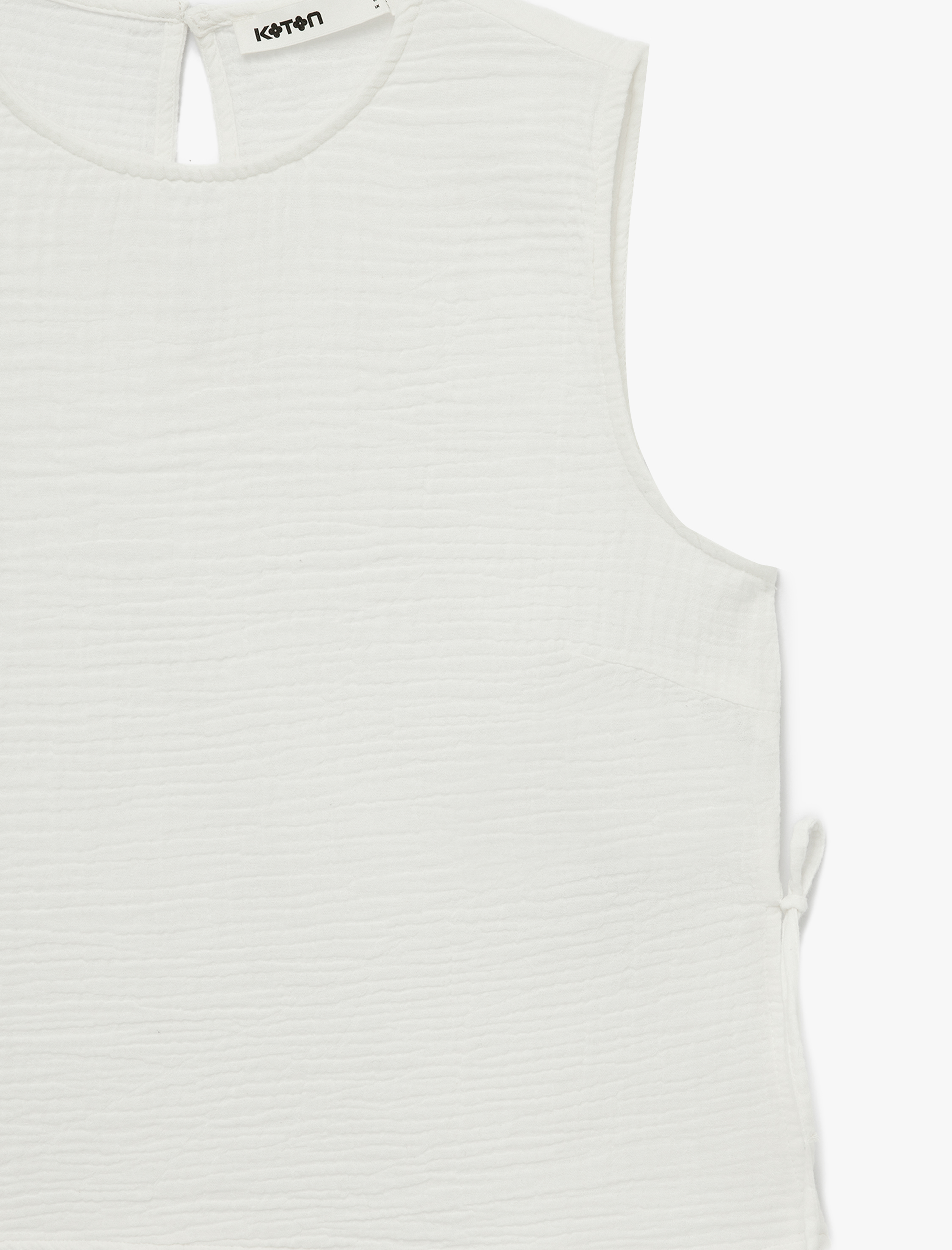   Pamuklu Yuvarlak Yaka Yanları Bağlamalı Fiyonklu Kolsuz Müslin Bluz