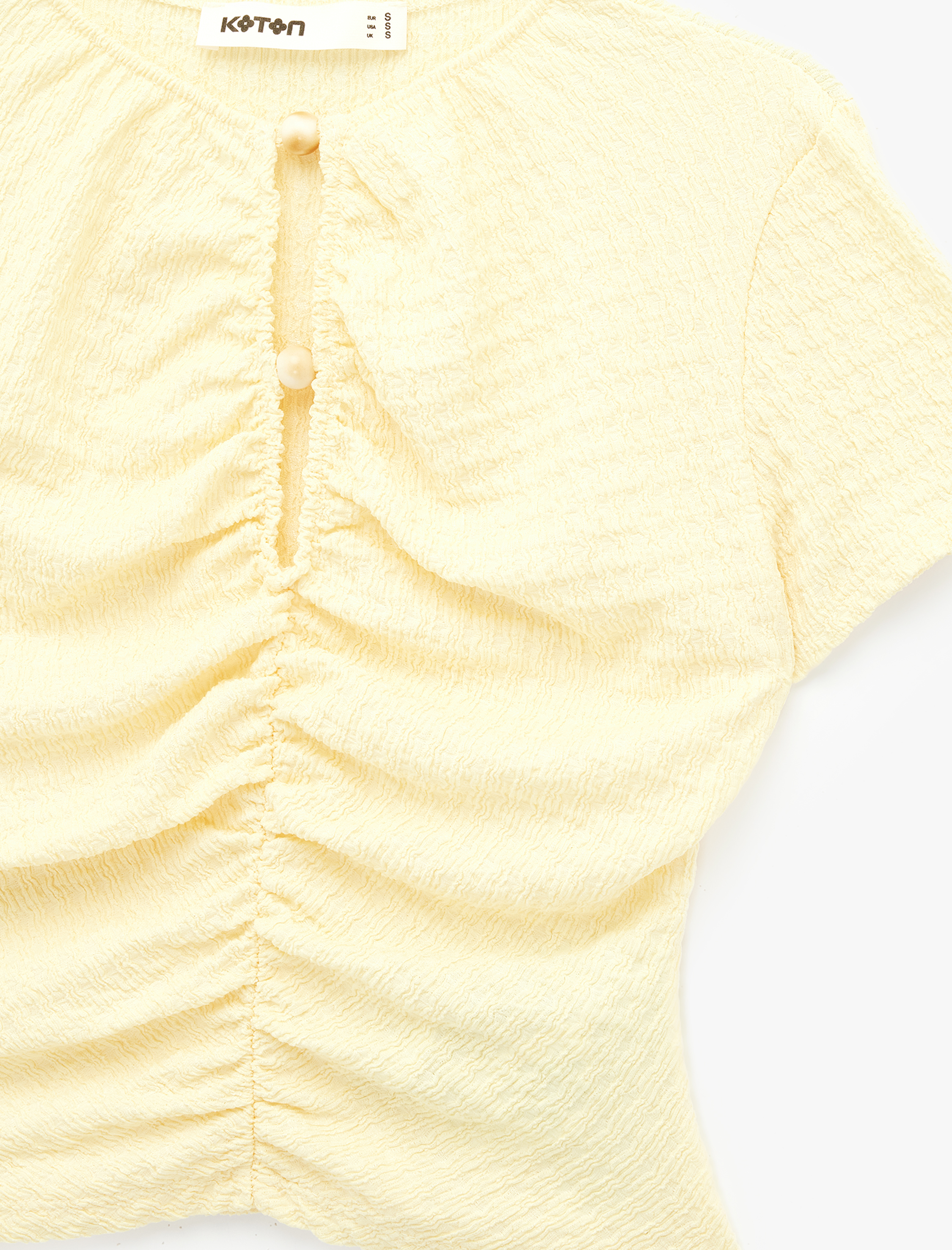   Bürümcük Kumaş Dokulu Slim Fit Kısa Kollu Pencere Detaylı Drapeli Bluz