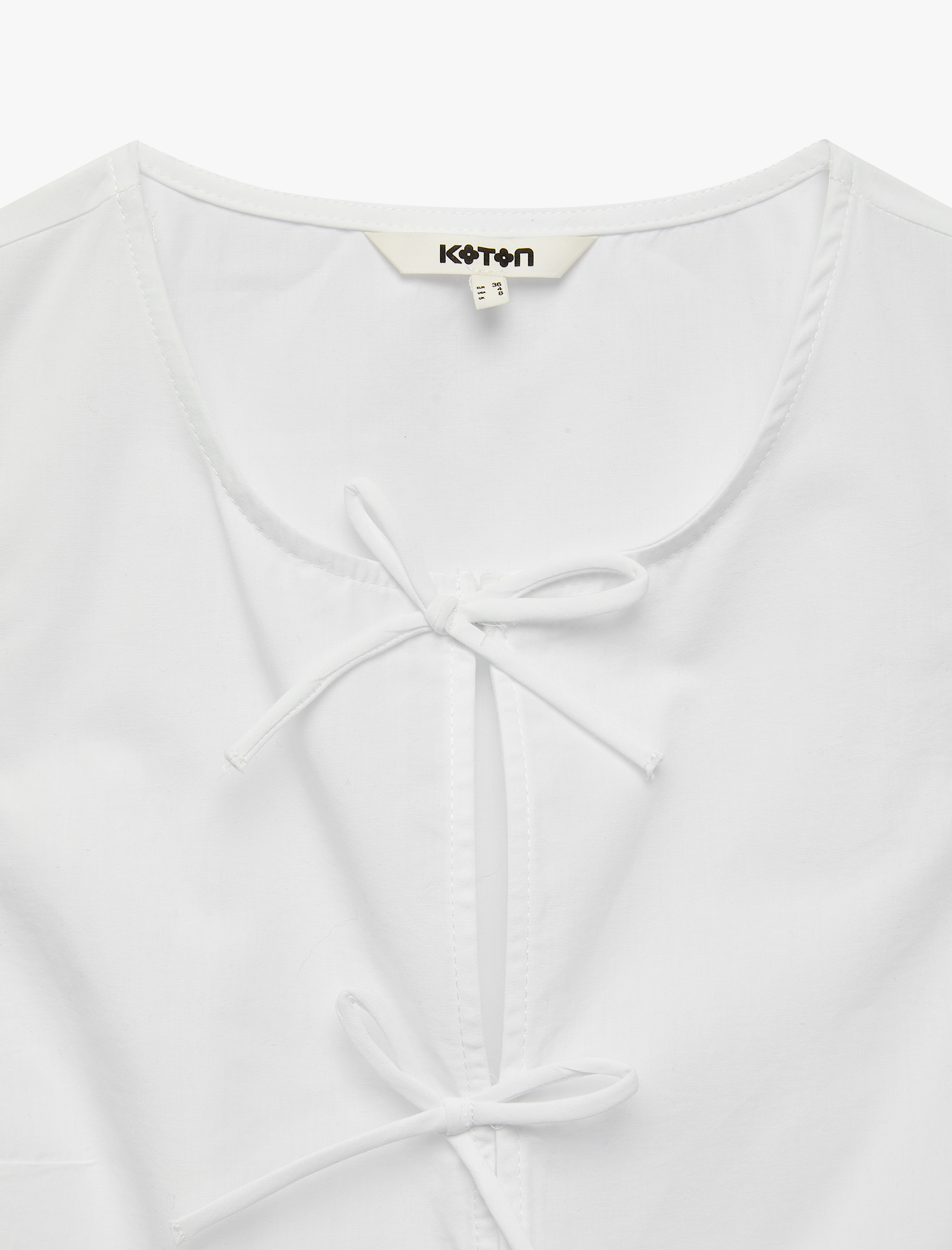   Pamuklu Kolsuz Yuvarlak Yaka Peplum Kesim Fiyonklu Poplin Bluz
